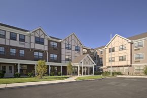 Elkins Park apartment for rent - an exterior view of an apartment building with a parking lot