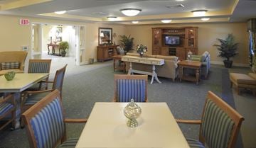 Laurel apartment for rent - a dining room with tables and chairs and a living room with a television