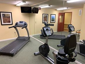 Baltimore apartment for rent - A fully equipped gym with a treadmill and a stationary bike.