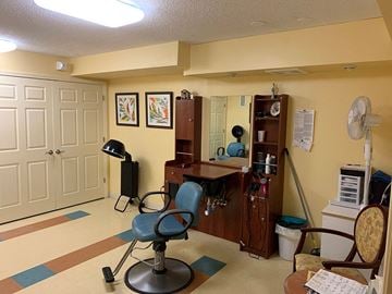 Baltimore apartment for rent - a living room with a desk and chairs and a fan