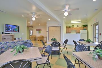 Red Lion apartment for rent - a dining room with tables and chairs and a living room with a television