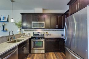 Madison apartment for rent - a kitchen with stainless steel appliances and wooden cabinets
