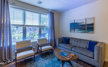 Madison apartment for rent - a living room with a couch and chairs and a large window