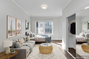 San Francisco apartment for rent - A living room with a grey couch, a wooden table, and a wicker ottoman.