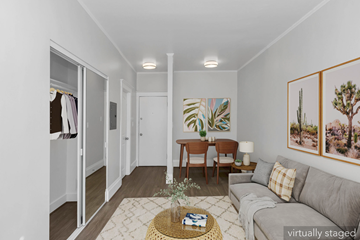 San Francisco apartment for rent - A living room with a grey couch, a coffee table, and a painting on the wall.