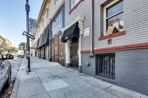 San Francisco apartment for rent - A street view of a building with a black awning and a sign that says "Bakery".
