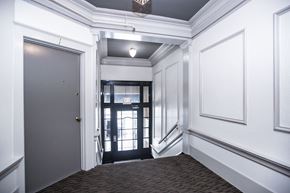 San Francisco apartment for rent - A hallway with a black door and a white wall.