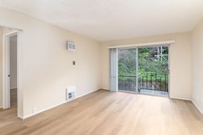 San Francisco apartment for rent - A room with a sliding glass door leading to a backyard.