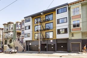 San Francisco apartment for rent - A row of multi-story buildings with a car parked on the street.