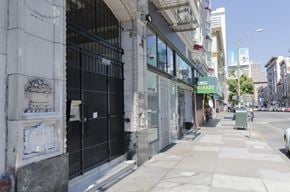 San Francisco apartment for rent - A street view of a city with a building that has a sign that says "Jim's Market".