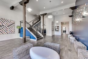 San Francisco apartment for rent - A white table is in the middle of a room with a staircase.
