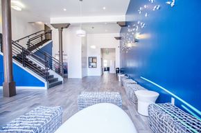 San Francisco apartment for rent - A blue wall with a staircase and a white chair.