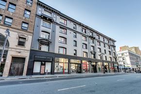 San Francisco apartment for rent - A street view of a row of buildings with shops on the ground floor.