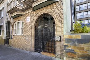 San Francisco apartment for rent - A building with a black gate and a brick facade.