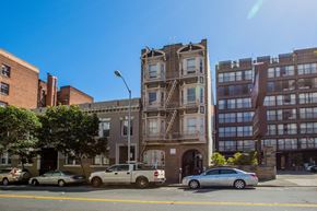 San Francisco apartment for rent - A street view of a city with cars and buildings.