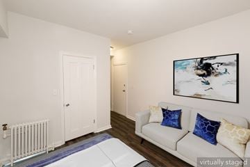 San Francisco apartment for rent - A living room with a white couch and a painting on the wall.