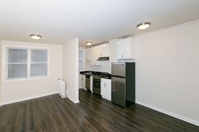 San Francisco apartment for rent - A kitchen with black countertops and white cabinets.