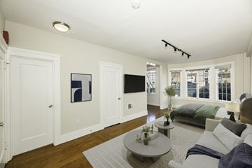San Francisco apartment for rent - A living room with a couch, coffee table, and a painting on the wall.