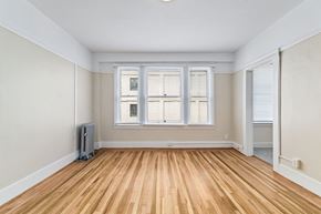 San Francisco apartment for rent - A room with wooden flooring and a window with blinds.