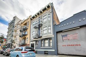 San Francisco apartment for rent - A street view with a car parked in front of a building with a no parking sign.