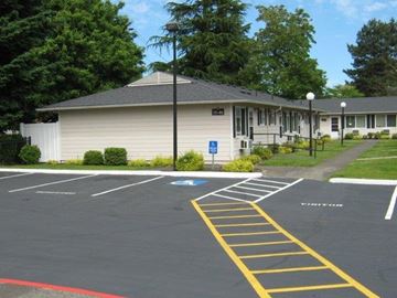 Portland apartment for rent - a parking lot in front of a white building