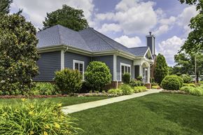 Millville apartment for rent - a blue house with a lawn and a sidewalk