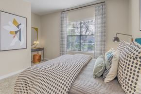 Charlotte apartment for rent - a bedroom with a large bed and a window