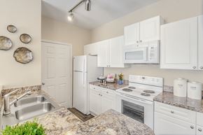 Charlotte apartment for rent - a kitchen with white appliances and granite counter tops
