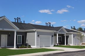 Muncy apartment for rent - a white house with a gray roof and a lawn