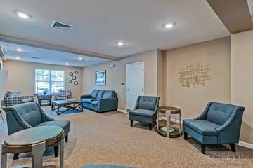 Zebulon apartment for rent - a living room with couches and chairs and a table
