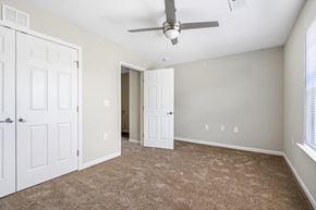 Rocky Mount apartment for rent - a bedroom with two doors and a ceiling fan