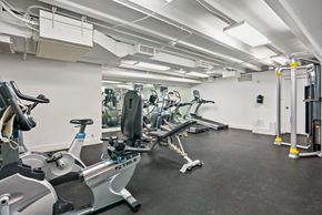 Washington apartment for rent - A gym with a row of treadmills and elliptical machines.