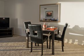 Washington apartment for rent - a dining room with a table and chairs and a tv