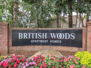 Nashville apartment for rent - a sign woods apartment homes in front of flowers