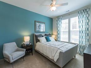 Hendersonville apartment for rent - a bedroom with a bed and a chair and a ceiling fan