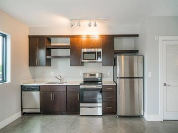 Nashville apartment for rent - a kitchen with stainless steel appliances and wooden cabinets