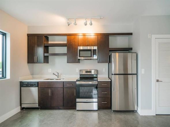 Nashville apartment for rent - a kitchen with stainless steel appliances and wooden cabinets