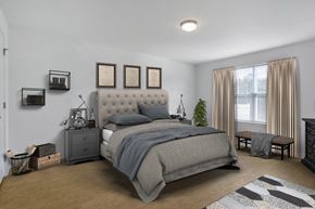 Manchester Township apartment for rent - a bedroom with white walls and a bed with grey blankets
