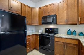 Manchester Township apartment for rent - a kitchen with black appliances and wood cabinets