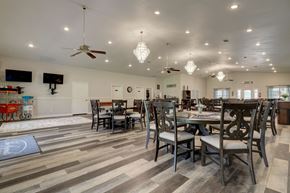 Lindale triplex for rent - A dining room with a long table at Legends of Lindale senior community