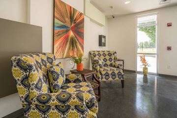 Nashville apartment for rent - a living room with chairs and a painting on the wall