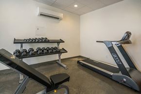 Nashville apartment for rent - a gym with treadmills and weights in the corner of a room