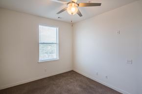 Nashville apartment for rent - a bedroom with a ceiling fan and a window