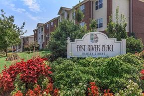 Nashville apartment for rent - a sign for east river place in front of an apartment building