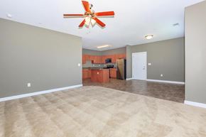 Nashville apartment for rent - an empty living room and kitchen with a ceiling fan