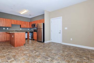 Nashville apartment for rent - a kitchen with wooden cabinets and a stainless steel refrigerator