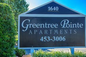 Lebanon apartment for rent - a sign for greentree point apartments in front of trees