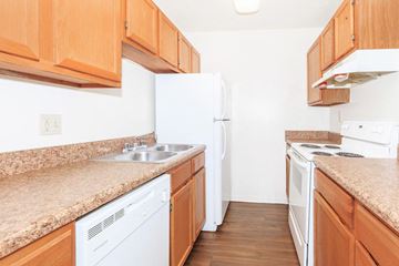 Hendersonville apartment for rent - a kitchen with wooden cabinets and white appliances