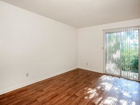 Jackson apartment for rent - an empty living room with a wood floor and a sliding glass door
