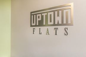 Nashville apartment for rent - a sign for uptown fats on a wall